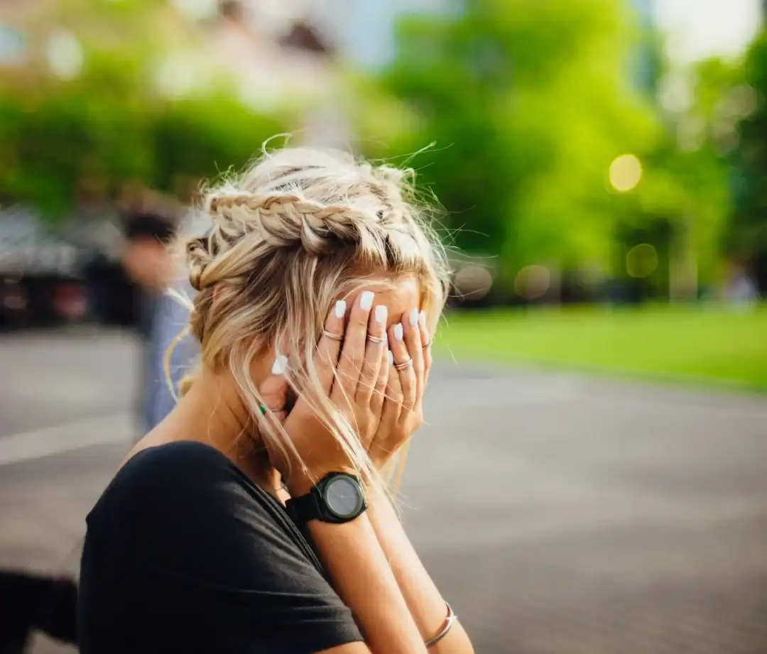 Chiropractic Anaheim CA Woman Covering Face